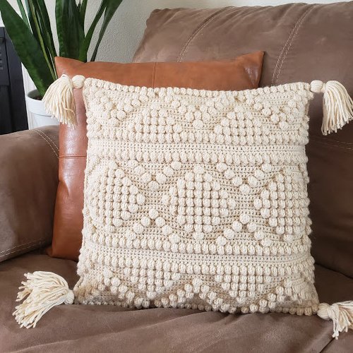 Picture of cream colored crochet pillow with a diamond pattern