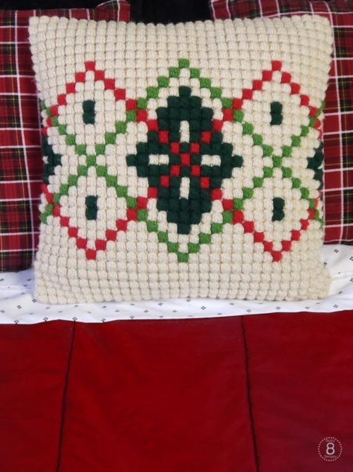 Picture of cream, red, and green colored bobble stitch crochet argyle Christmas pillow